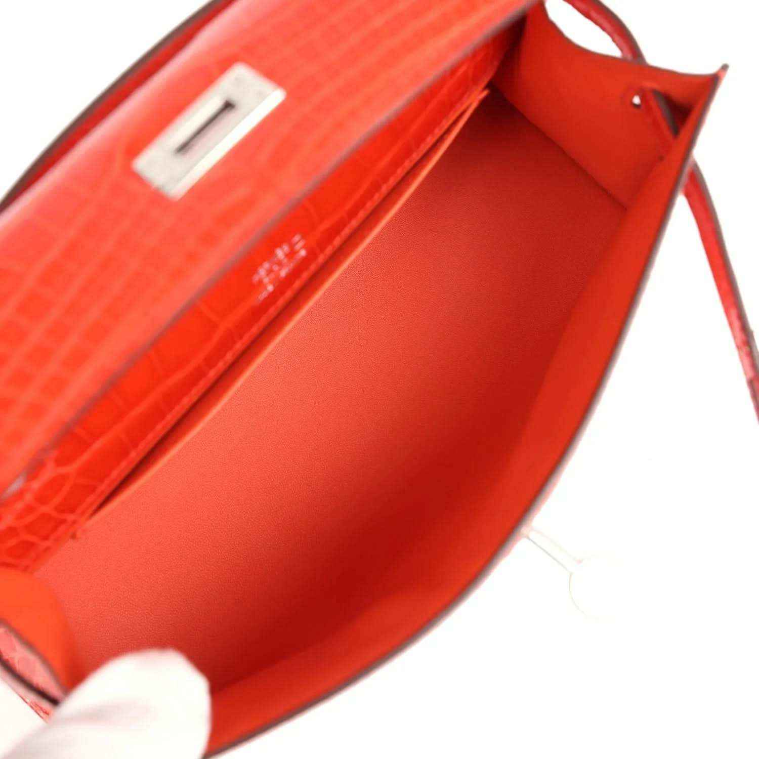 Orange crocodile-texture interior with stitched label panel and clasp hinge