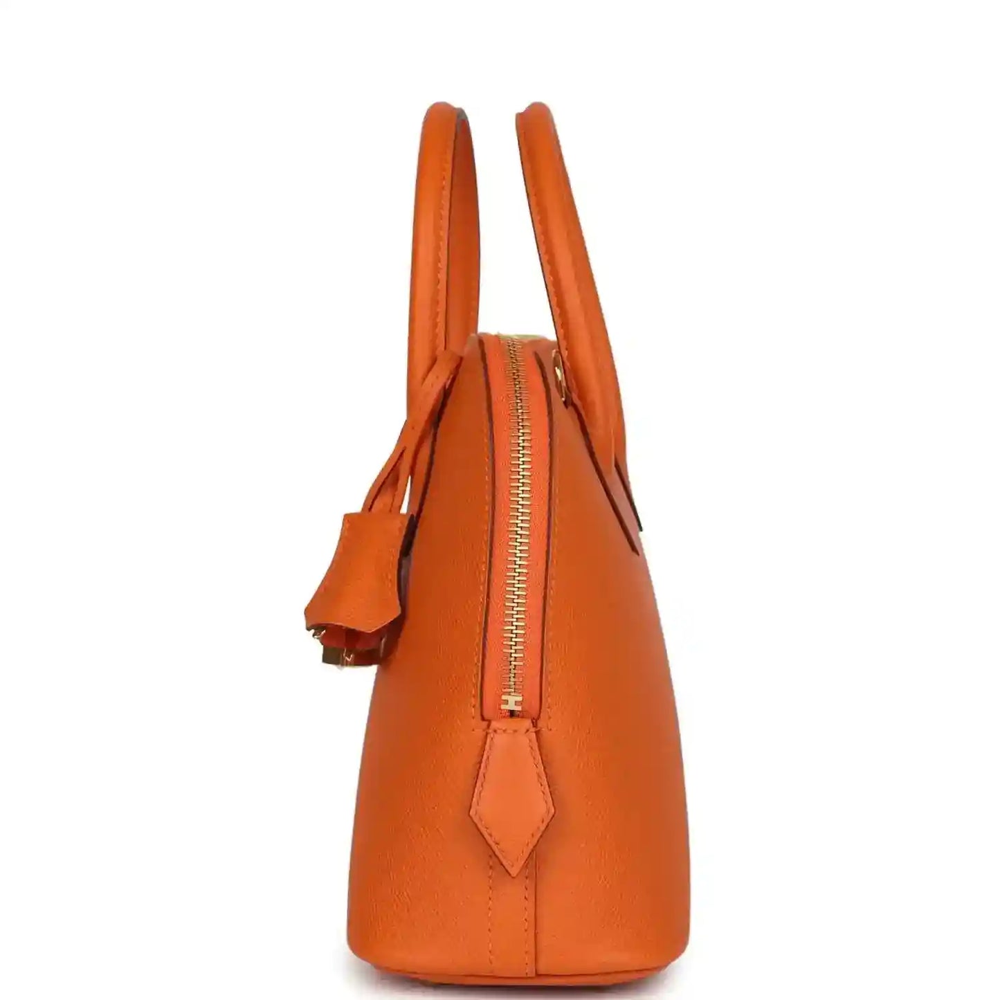 Orange leather handbag back view with zip closure, gold zipper pull, and hanging leather tab.