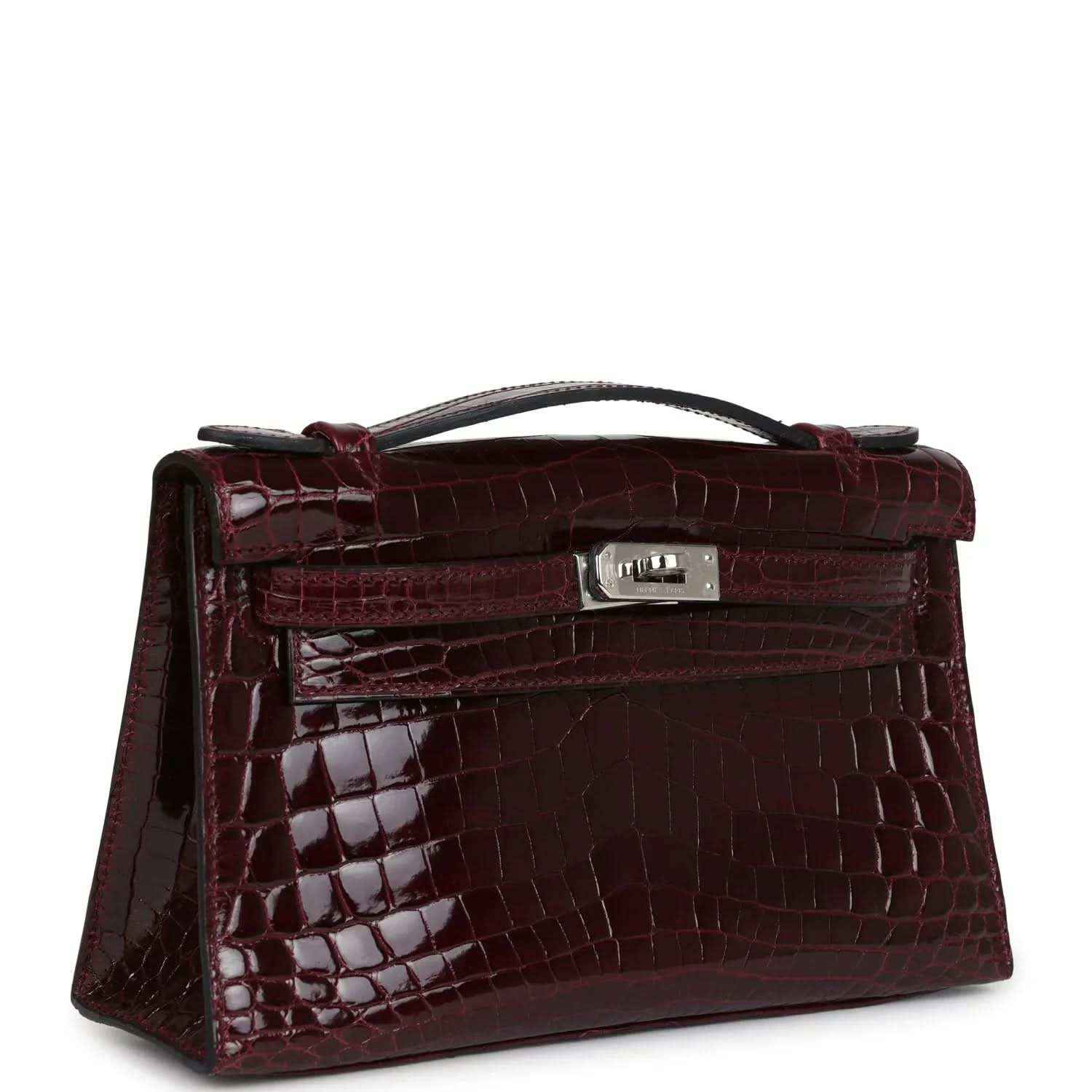 Burgundy crocodile-pattern handbag with top handle and rectangular front clasp