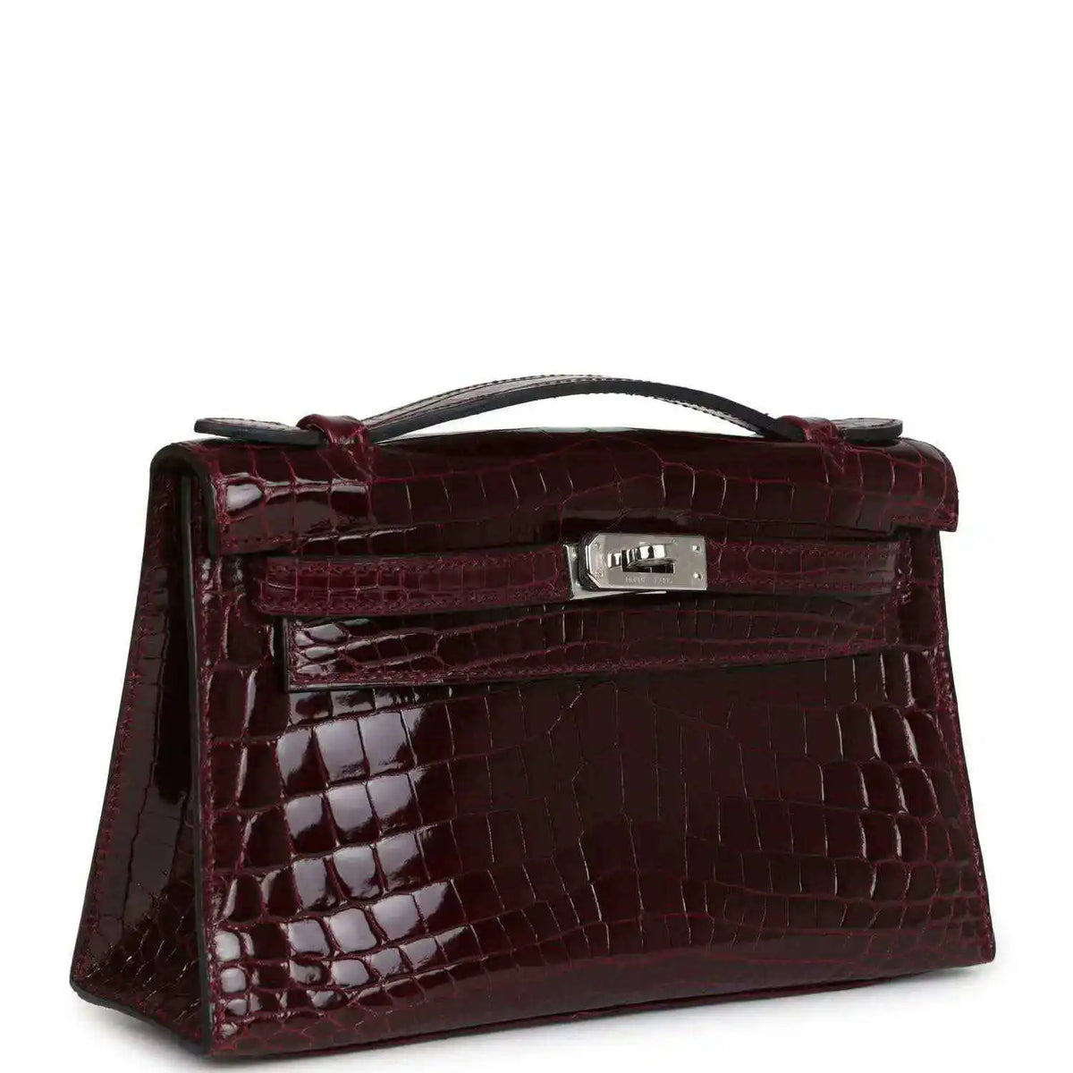 Burgundy crocodile-pattern handbag with top handle and rectangular front clasp