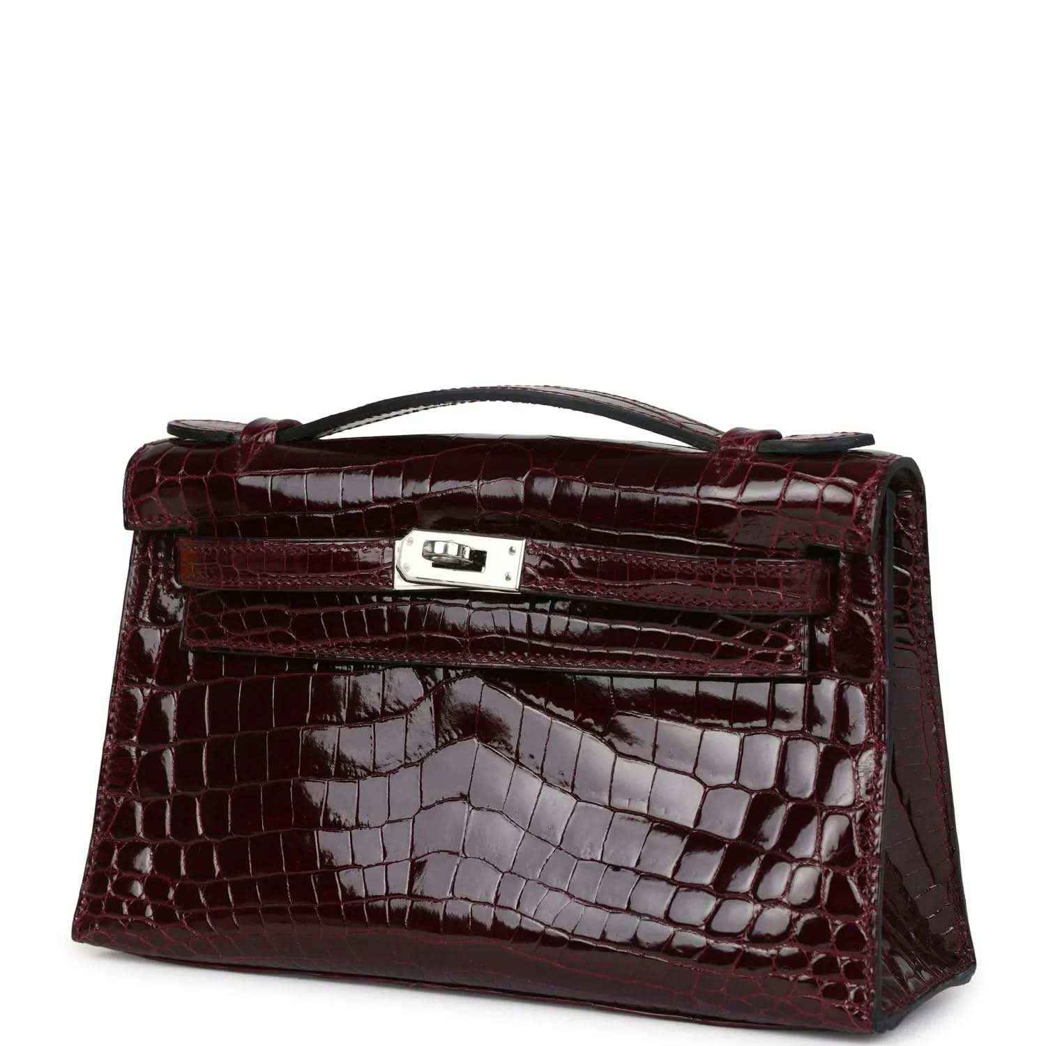 Burgundy crocodile-pattern handbag angled view with front clasp and handle
