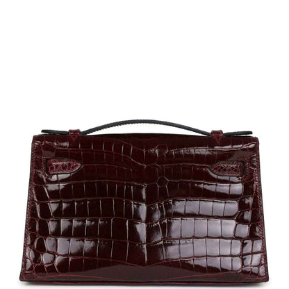 Burgundy crocodile-pattern handbag with flap front and top handle