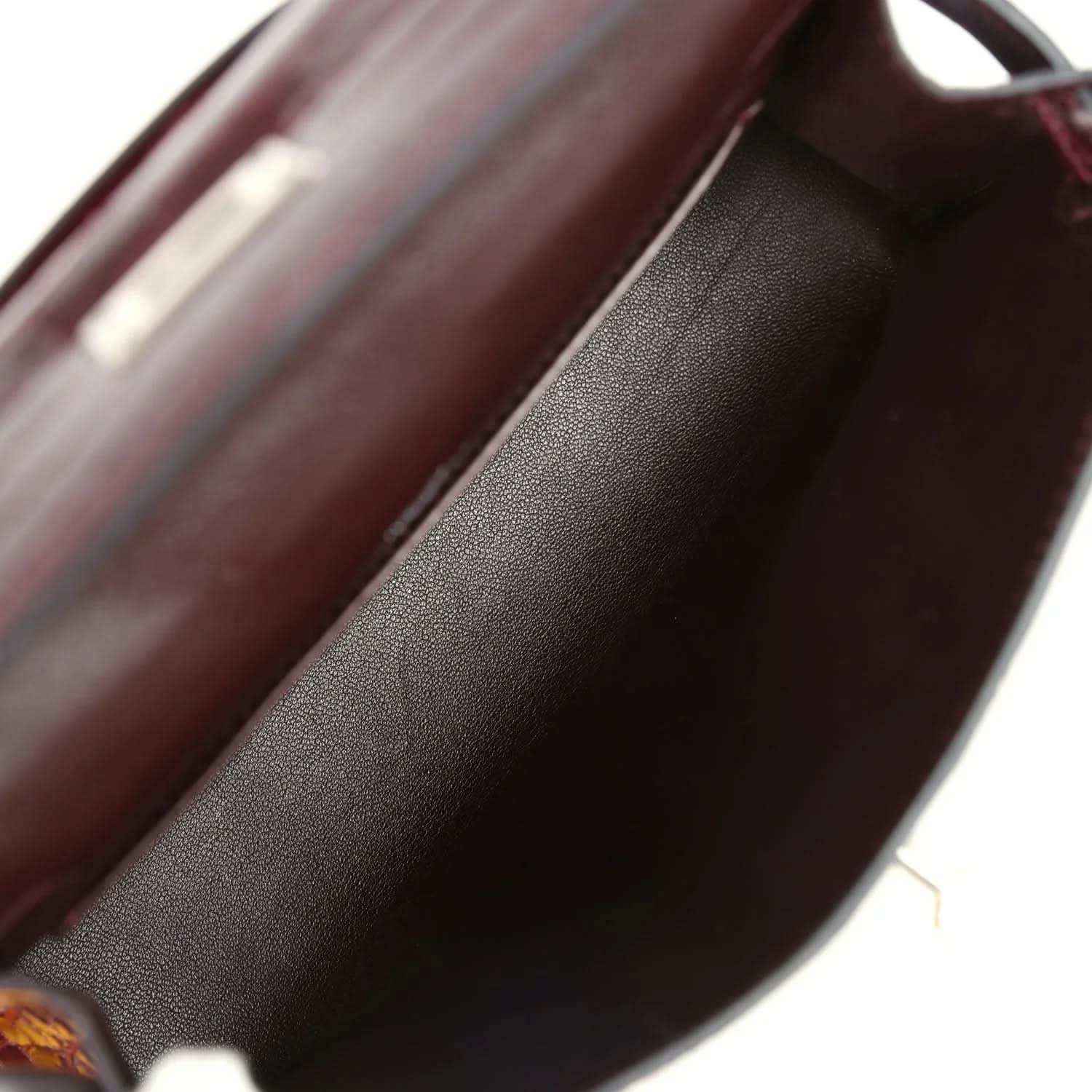Burgundy handbag interior lining with smooth leather texture close-up