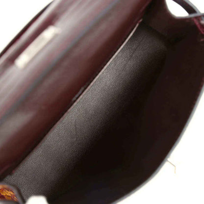 Burgundy handbag interior lining with smooth leather texture close-up