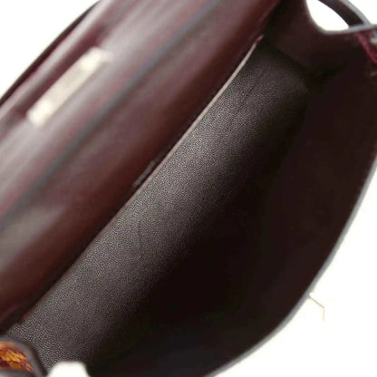 Burgundy handbag interior lining with smooth leather texture close-up