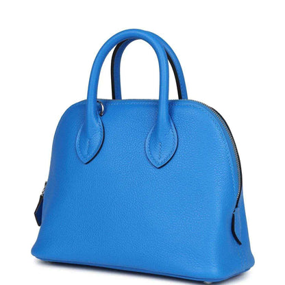 Mini Bolide bag in bright blue textured leather with top handles and curved side profile
