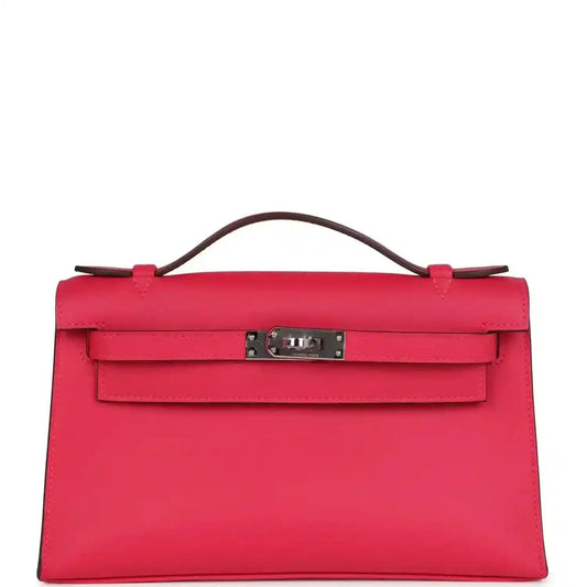 Pink leather handbag with top handle and front flap clasp