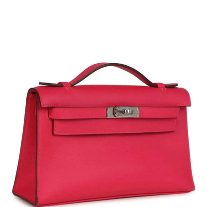 Pink leather handbag with top handle, front flap, and side view