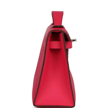 Pink leather handbag with open front flap and interior pocket