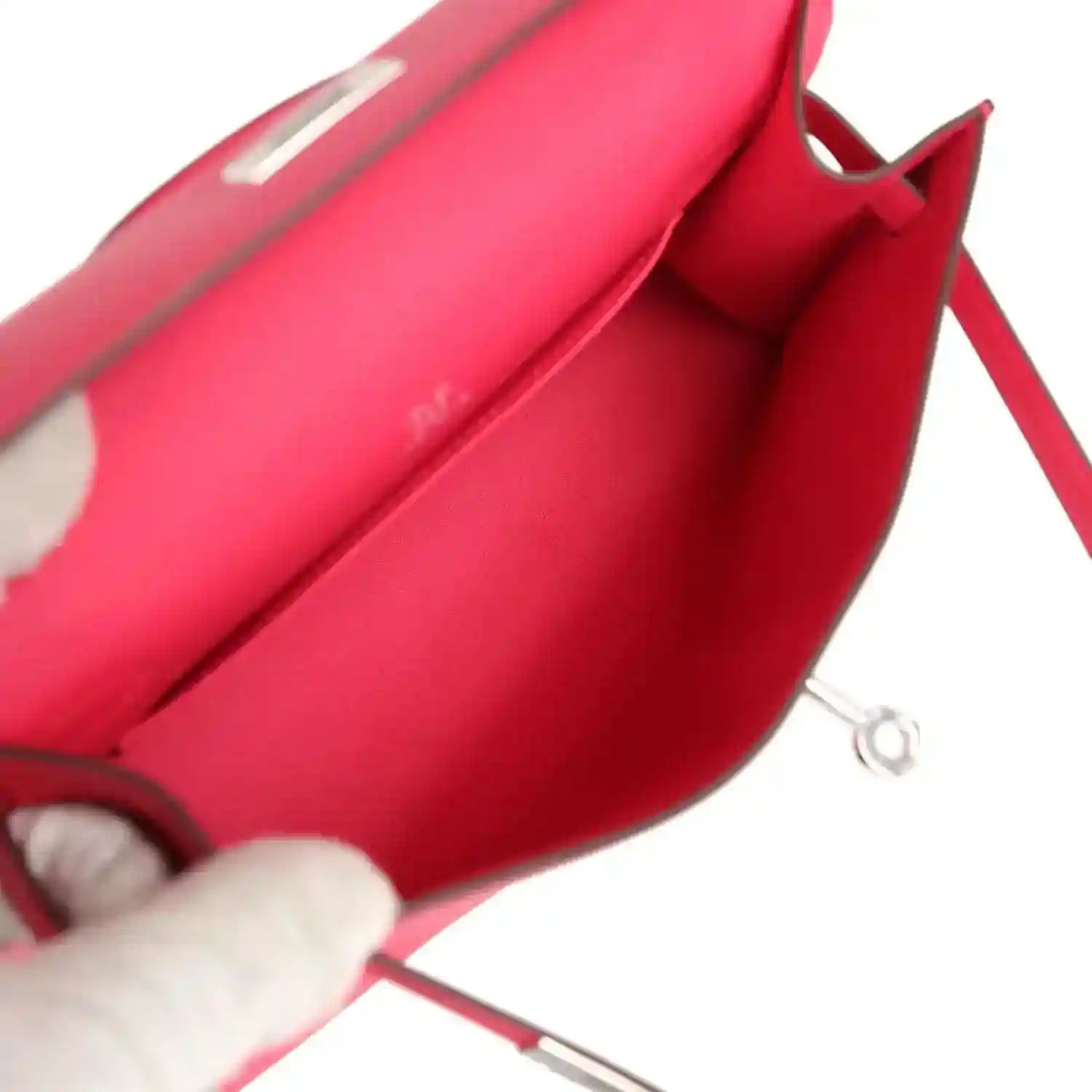 Pink leather handbag interior with metal ring and strap detail