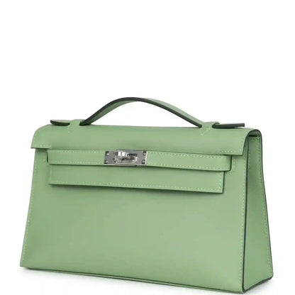 Hermes Kelly pochette angled view in light green leather with front lock