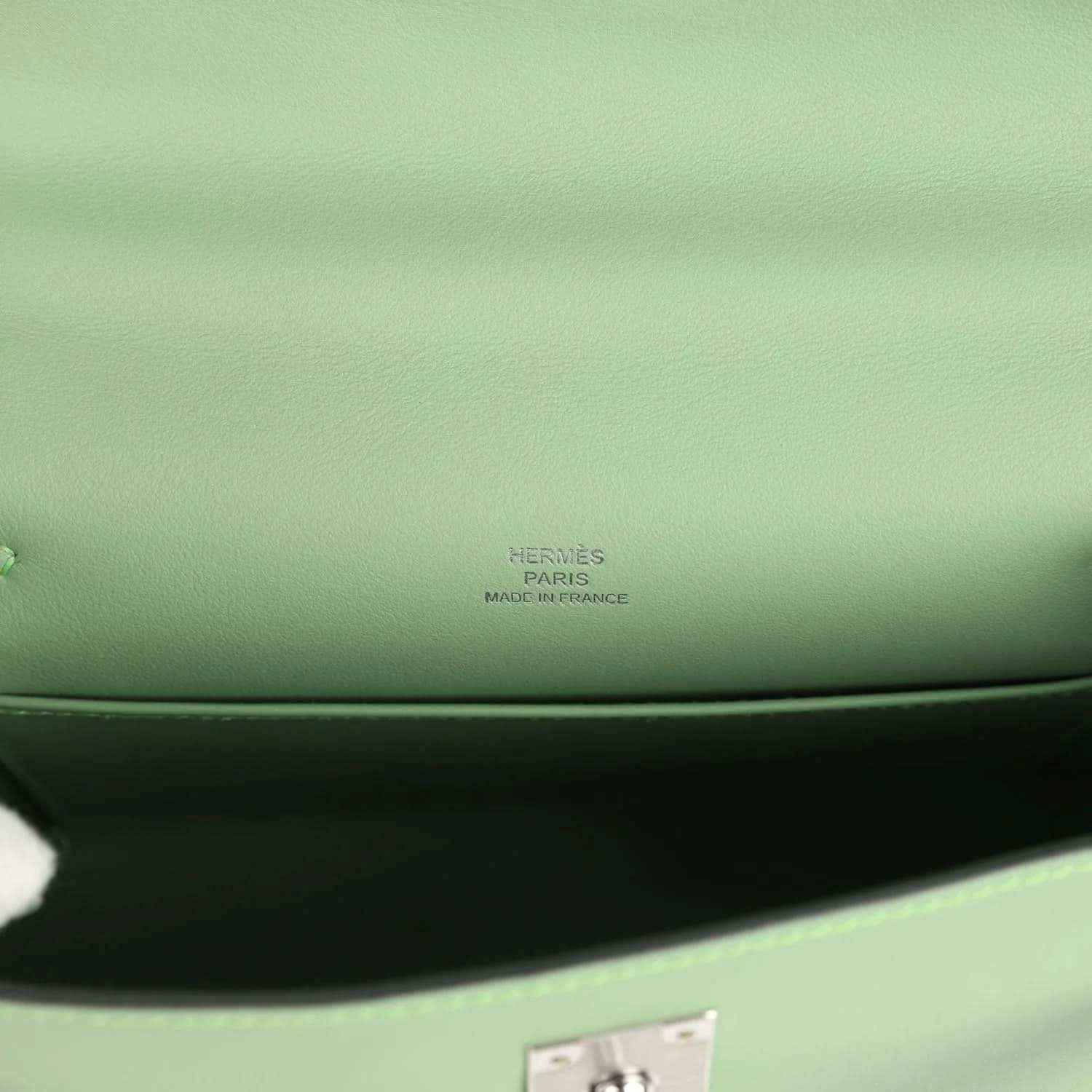 Hermes leather pochette stamp on light green lining near inner seam