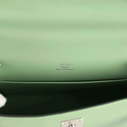 Hermes leather pochette stamp on light green lining near inner seam