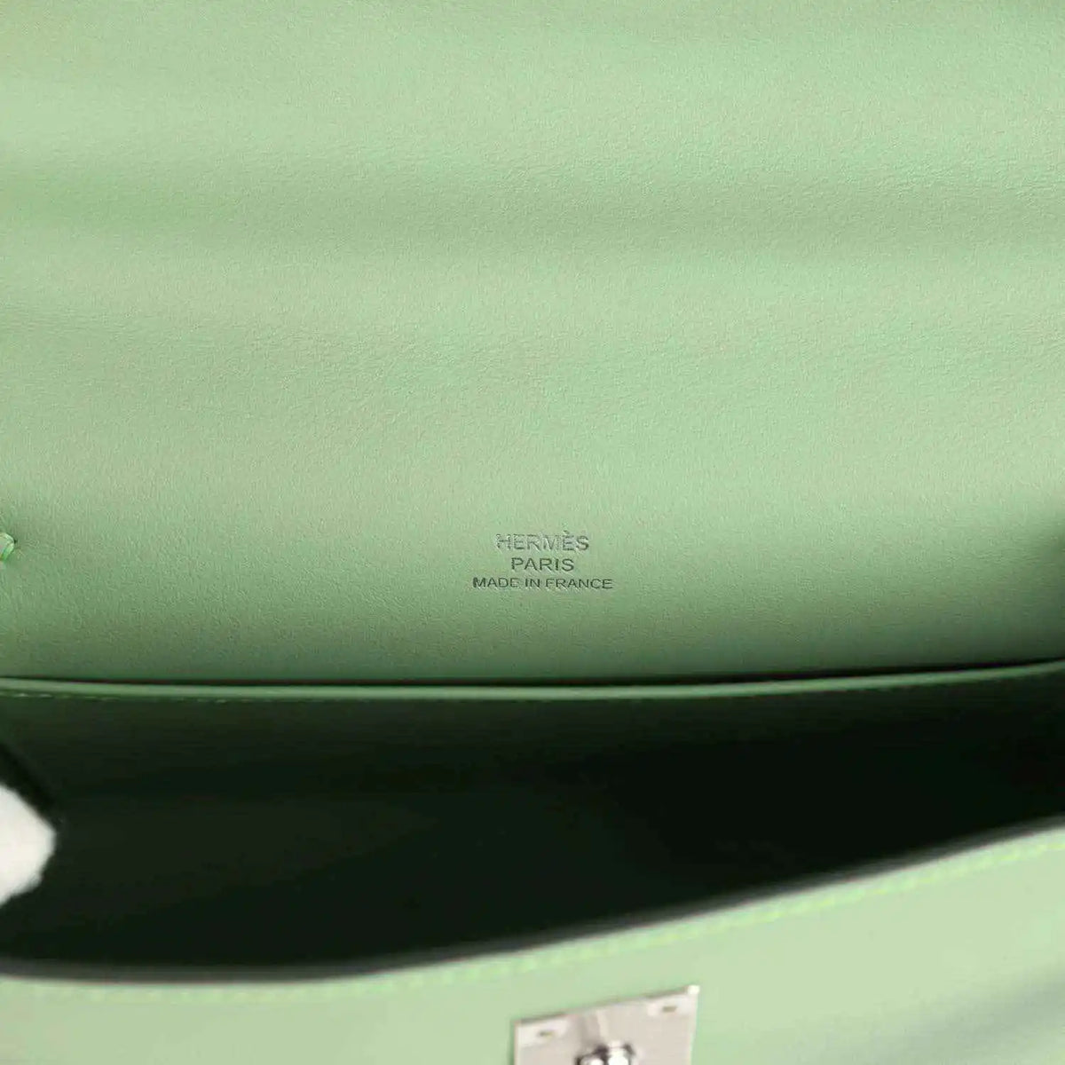 Hermes leather pochette stamp on light green lining near inner seam