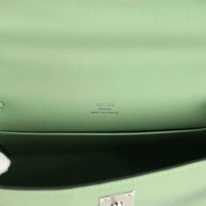 Hermes leather pochette stamp on light green lining near inner seam