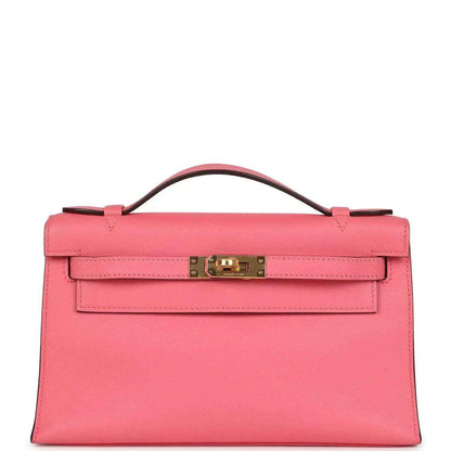 Hermes Kelly pochette bag in rose pink Swift leather with gold clasp and handle