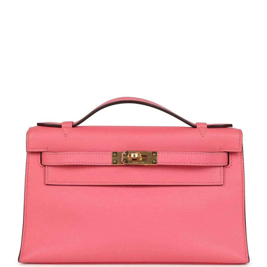 Hermes Kelly pochette bag in rose pink Swift leather with gold clasp and handle