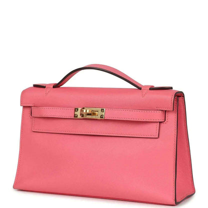 Hermes Kelly pochette bag with flap, rose pink leather and gold clasp, side profile