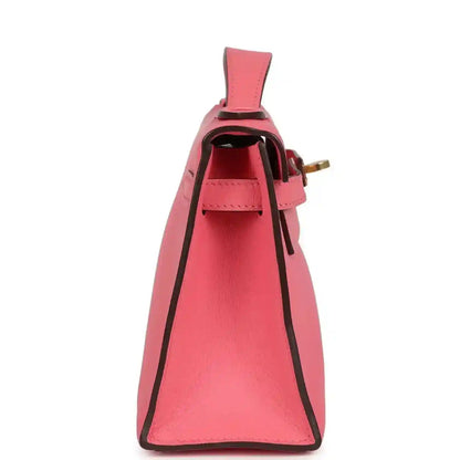 Hermes Kelly pochette bag side view, pink leather interior and strap loop