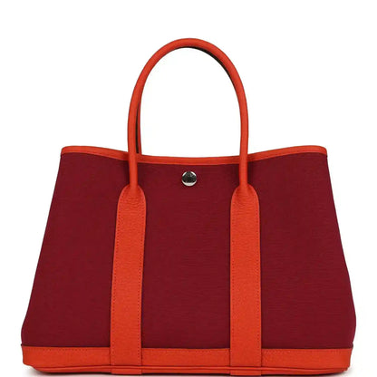Rubis canvas and leather tote bag with two top handles and front metal snap