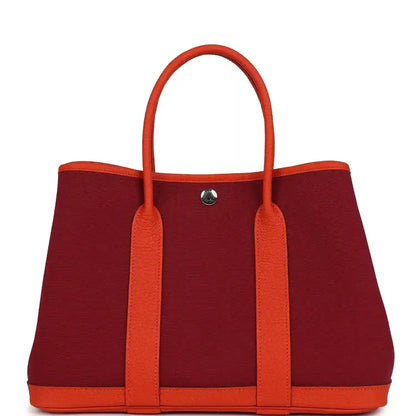 Rubis canvas tote bag with orange leather handles, front center metal snap
