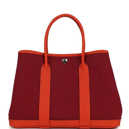 Rubis canvas tote bag with orange leather handles, front center metal snap