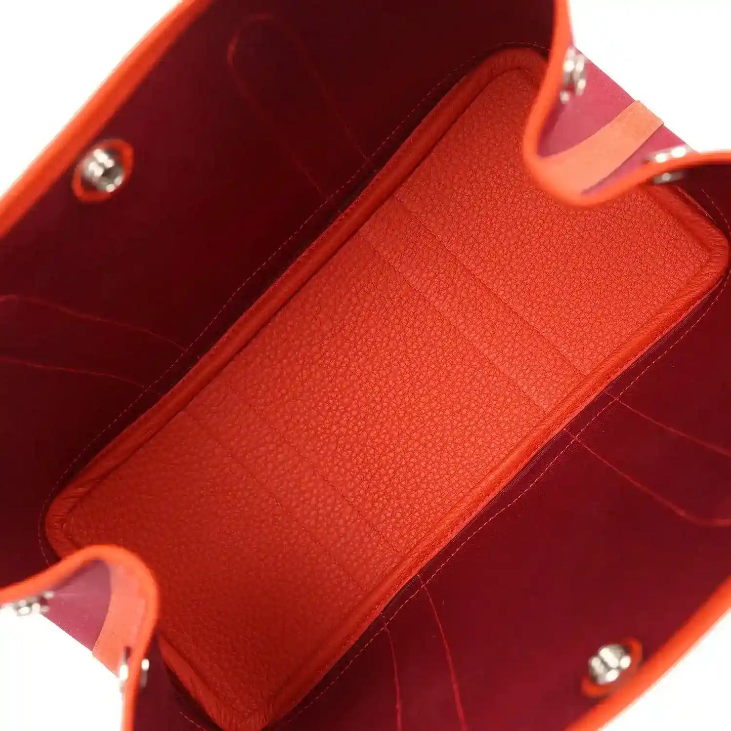 Rubis canvas tote interior with textured orange leather panel and silver hardware