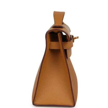 Tan leather Kelly pochette handbag, side view showing interior opening