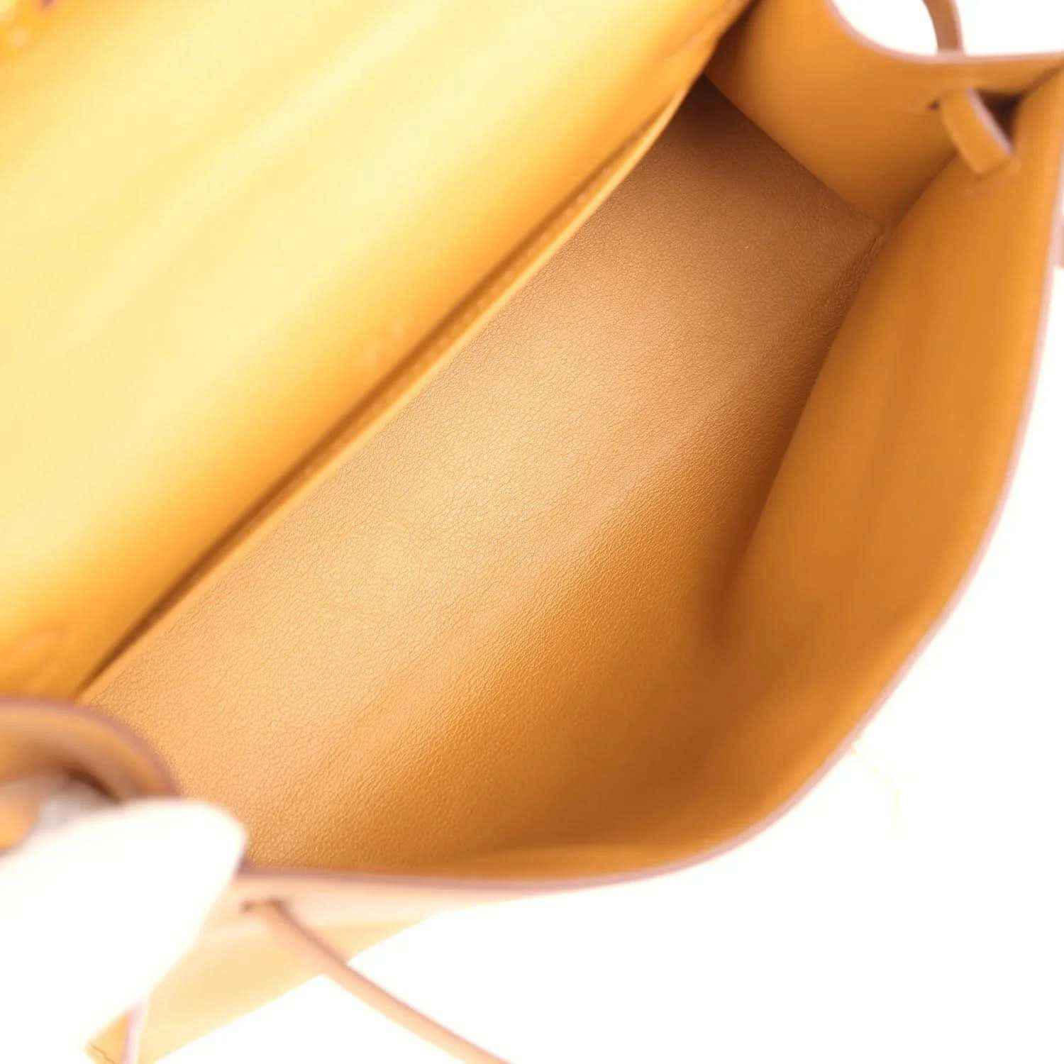 Tan leather handbag interior view with stitched lining and side pocket