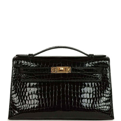 Black shiny crocodile skin handbag with top handle and gold front clasp