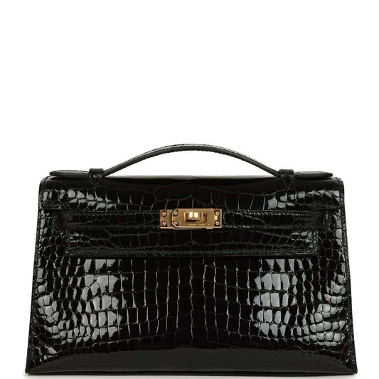 Black shiny crocodile skin handbag with top handle and gold front clasp