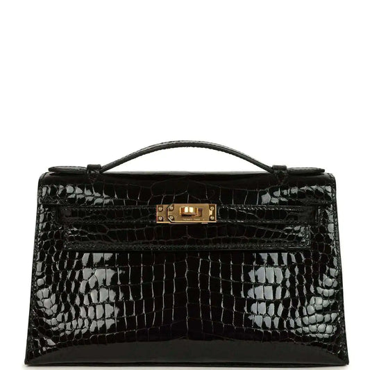 Black shiny crocodile skin handbag with top handle and gold front clasp