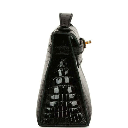 Black glossy crocodile skin mini handbag with raised top loop and gold hardware