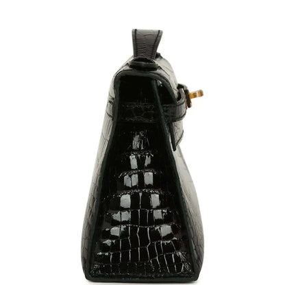 Black glossy crocodile skin mini handbag with raised top loop and gold hardware