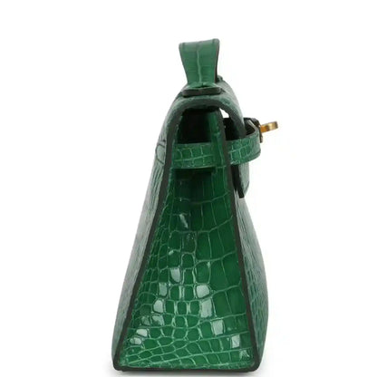 Hermes Kelly clutch side view in green crocodile with gold clasp hardware