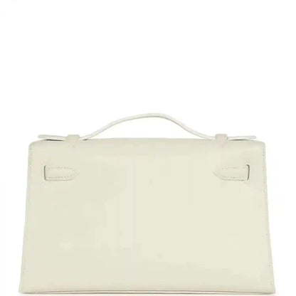 White leather clutch bag with top handle and front flap, viewed from back