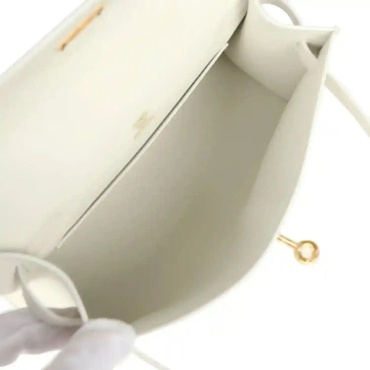 White leather clutch interior with gold ring clasp and stitched lining