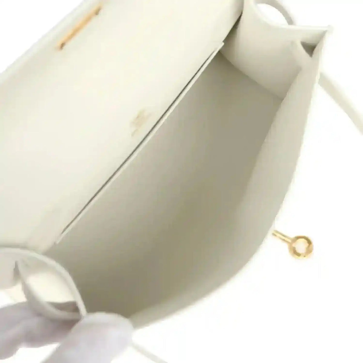 White leather clutch interior with gold ring clasp and stitched lining