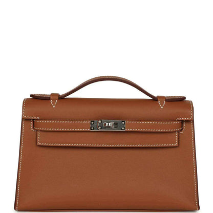 Brown leather top-handle clutch with front lock and stitched flap