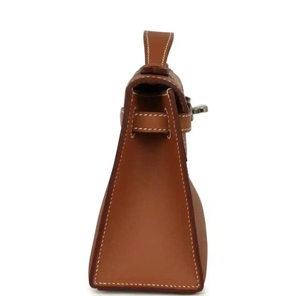 Brown leather clutch with top handle and side button detail