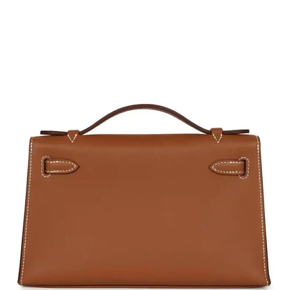 Brown leather handbag clutch with stitched flap, front lock, and top handle