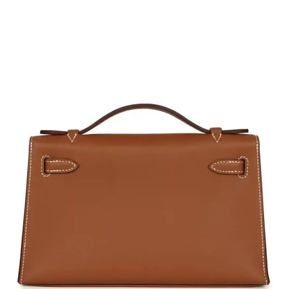 Brown leather handbag clutch with stitched flap, front lock, and top handle