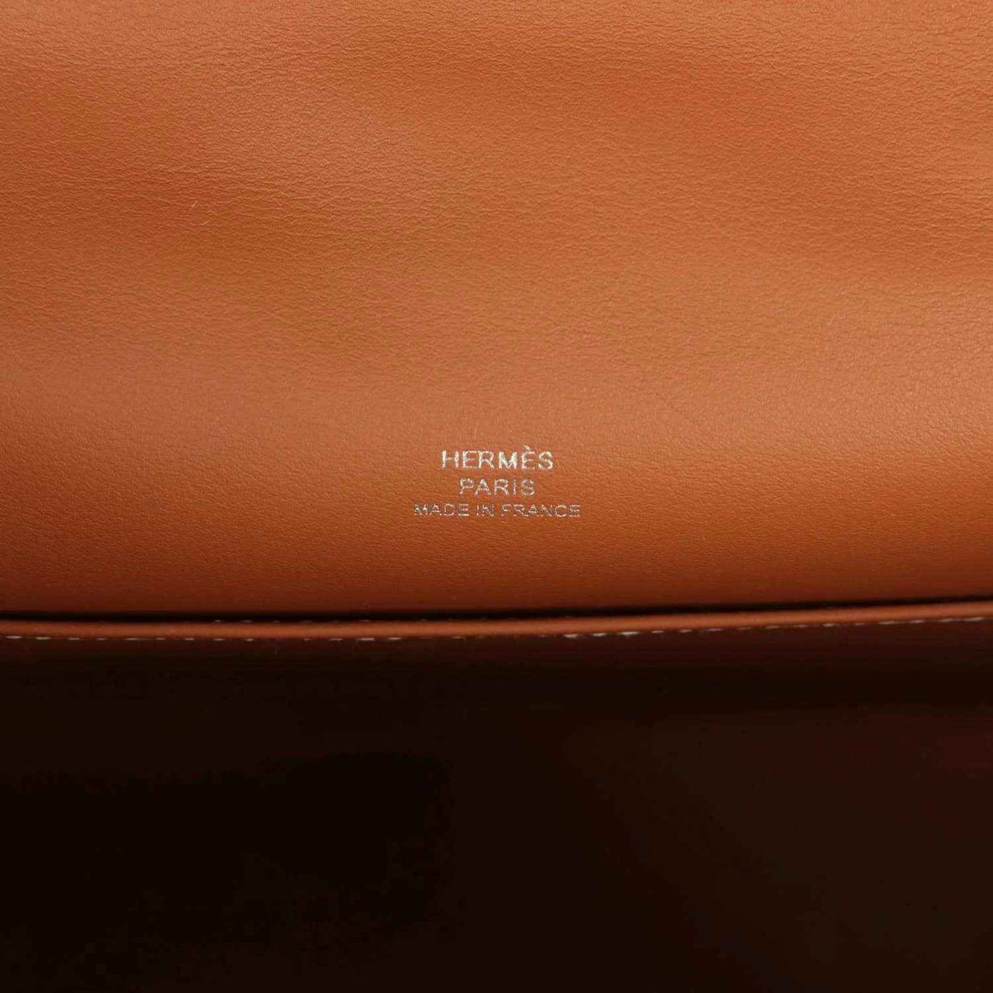 Brown leather clutch with HERMES Paris stamp on the front panel