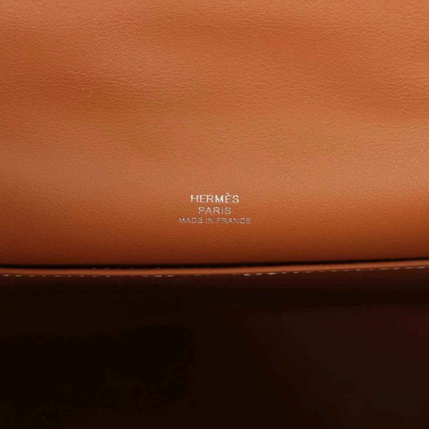 Brown leather clutch with HERMES Paris stamp on the front panel