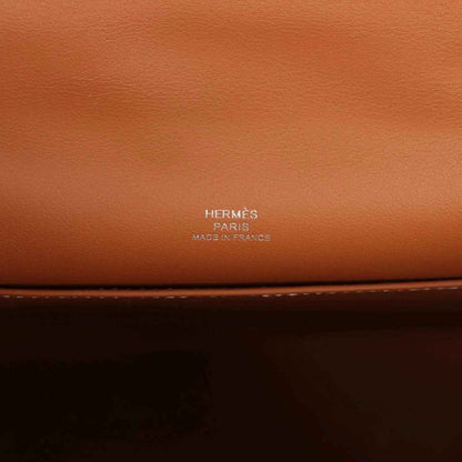Brown leather clutch with HERMES Paris stamp on the front panel