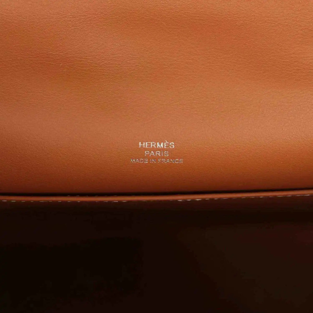 Brown leather clutch with HERMES Paris stamp on the front panel