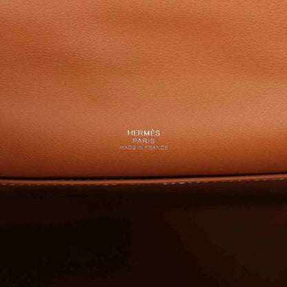 Brown leather clutch with HERMES Paris stamp on the front panel