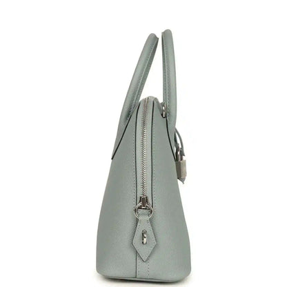 Light gray leather Bolide bag side view with zip top and lock charm detail