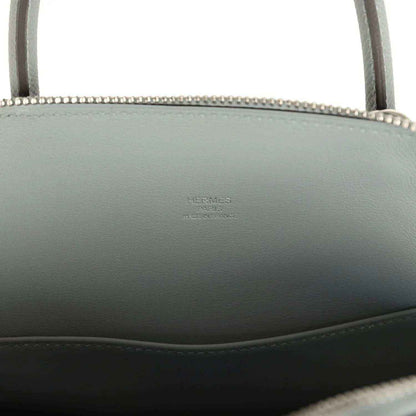 Light gray leather Bolide with embossed brand stamp on interior side