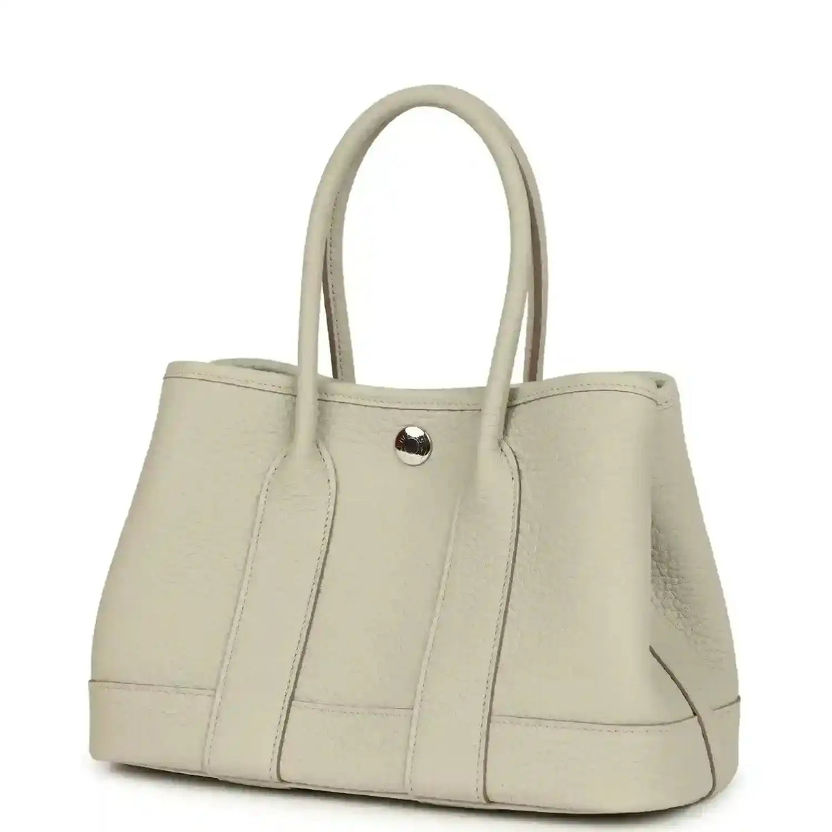 Hermes Garden Party Neo 23 tote bag angled view in light beige leather with front snap tab